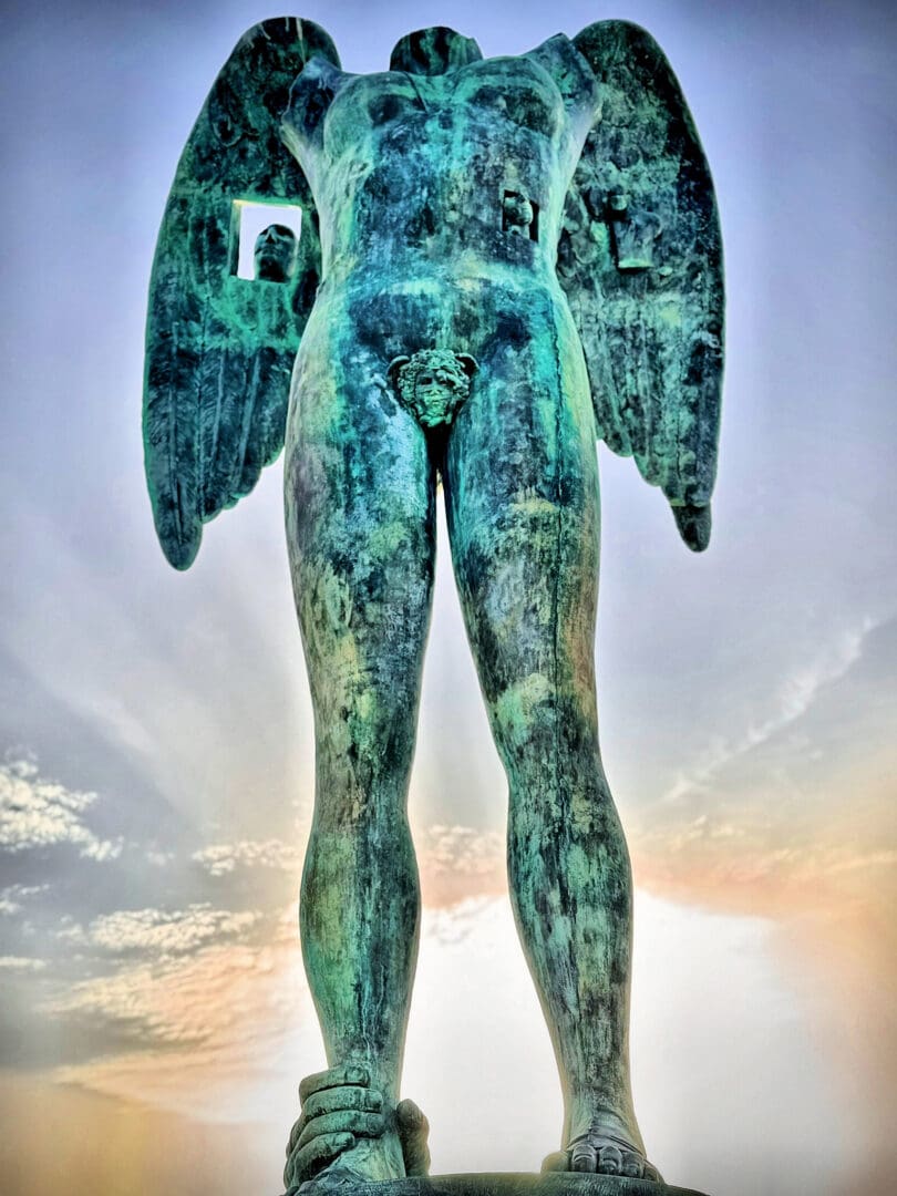 Bronze statue of a winged figure standing tall.