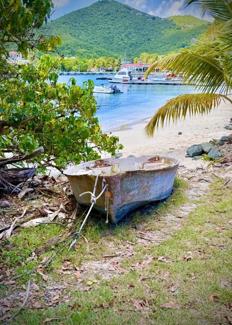 Abandoned boat near a serene beach.
