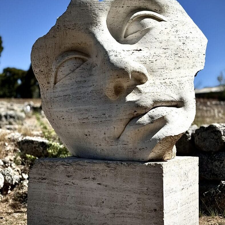 Abstract stone sculpture of a fragmented face.